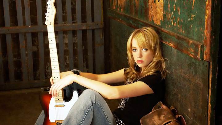 Alexz Johnson Sitting On Ground With A Guitar